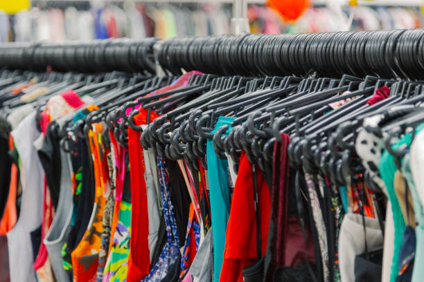 istock Beautiful colorful clothes in a store on hangers 1153647294
