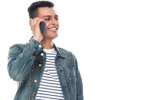 istock Good looking tall black man wearing denim jacket - talking on smart phone 1153647982