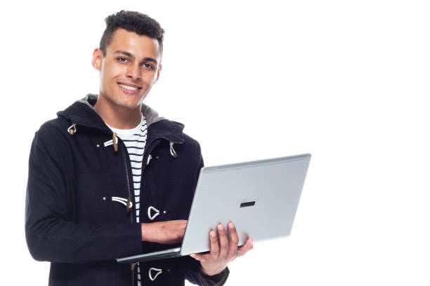 istock Handsome tall black man wearing a jacket on white background - holding laptop 1153648089