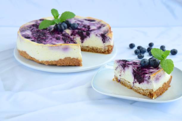istock Homemade blueberry swirl cheesecake with mint leaf 1153648457