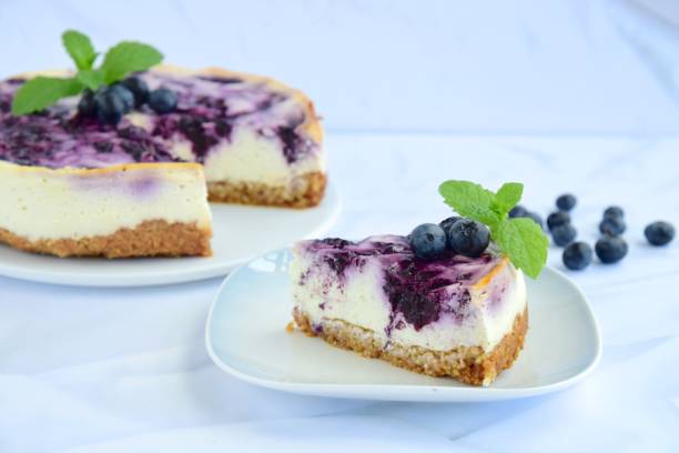 istock Homemade blueberry swirl cheesecake with mint leaf 1153648699