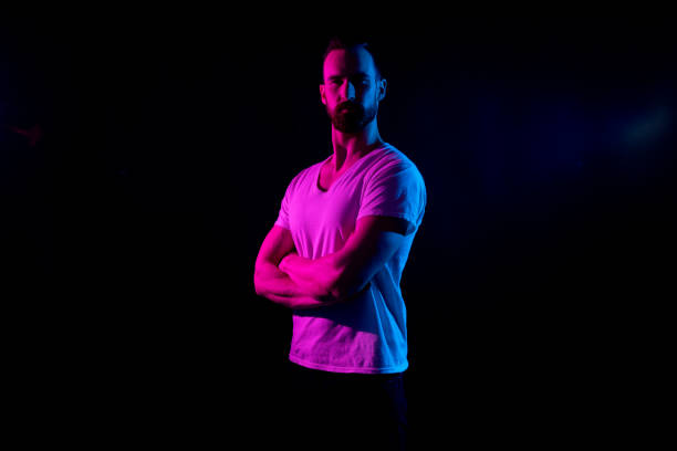 istock Handsome man in white tshirt with gel lighting 1153649809