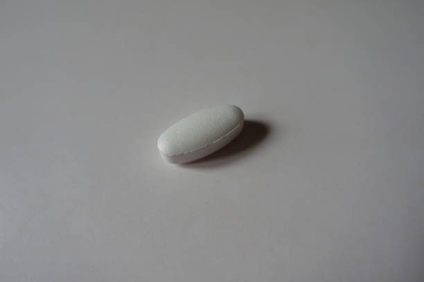Single big white oblong caplet of calcium citrate