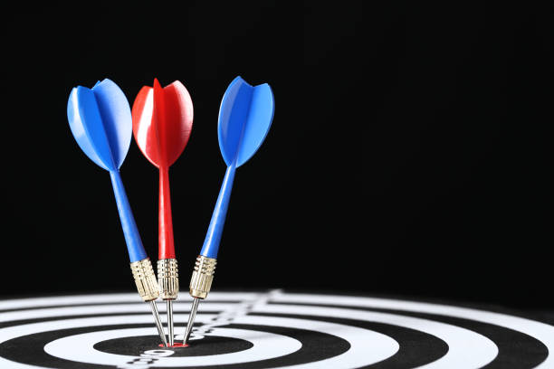 istock Dartboard with darts on black background 1153652842