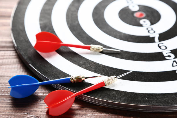 istock Dartboard with darts on brown wooden table 1153653014
