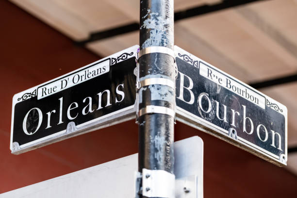 istock Orleans and Bourbon intersection Streets Sign text in New Orleans on lamp pole post isolated closeup 1153654509