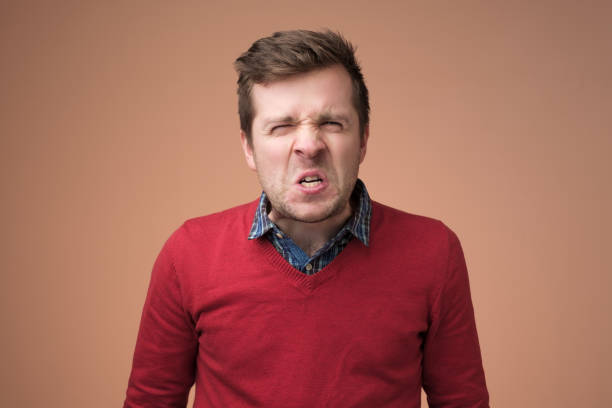 istock Angry caucasian man frowning his face in furious expression. 1153656266