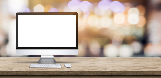 istock Blank screen desktop computer on wooden table top with blur bar restaurant bokeh background,Mock up for display or montage of design. 1153656658