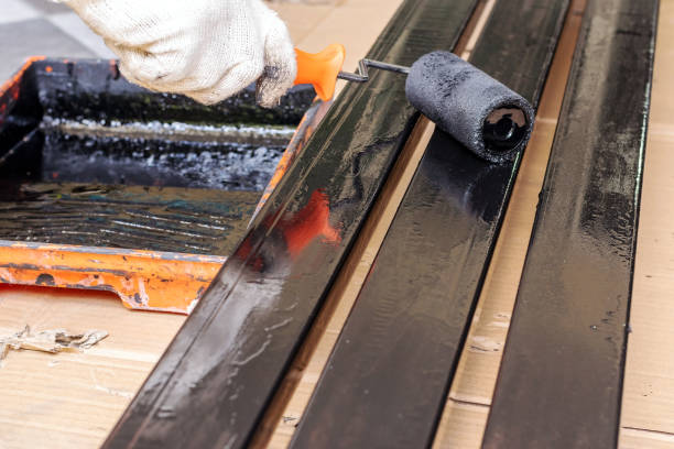 istock black paint roller on the steel rod. 1153660998