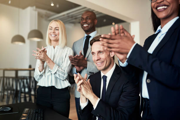 istock Smiling group of diverse businesspeople clapping after an office presentation 1153662026