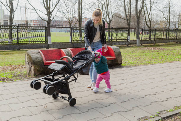 istock Young mother walks with a baby in a pram 1153662141