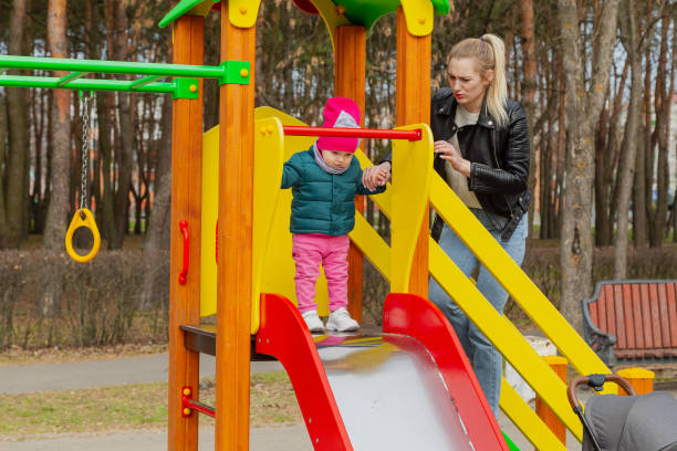 istock Happy mom and daughter play on the playground 1153663523