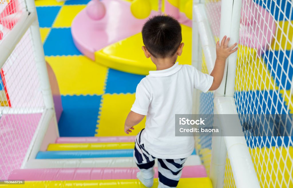 Little boy playing on obstacle course Little boy playing on obstacle course. Indoors Stock Photo Little boy playing on obstacle course Little boy playing on obstacle course. Indoors Stock Photo