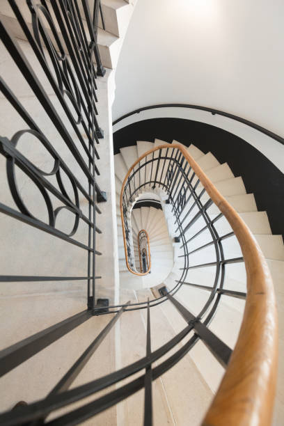 istock High angle view of spiral staircase winding downward 1153665812
