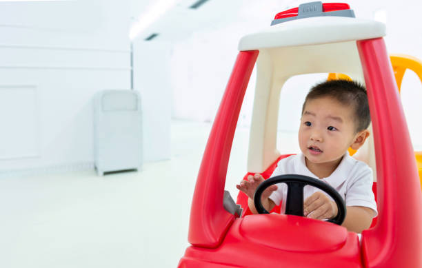 Little boy having fun in toy car.