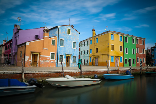 Venice, Italy - 04 07 2017: Tourists are sightseeing Burano canals colored houses Italy. Burano is an island in the Venetian Lagoon, northern Italy.