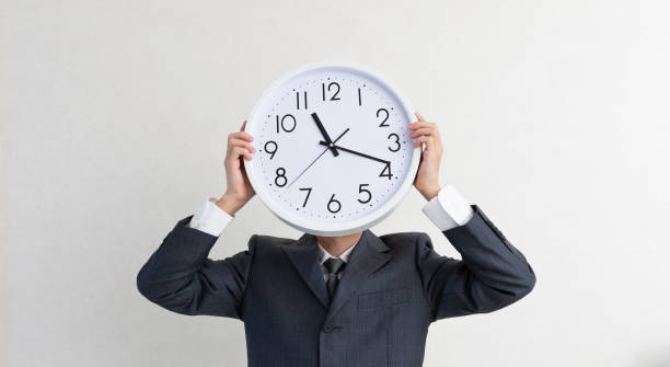 istock A businessman holding a clock 1153667464