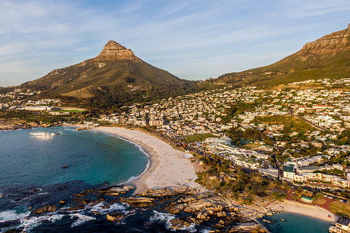 Drone shot of Camps Bay, an affluent suburb of Cape Town, South Africa, and the small bay on the west cost of the Cape Peninsula after which it is named.