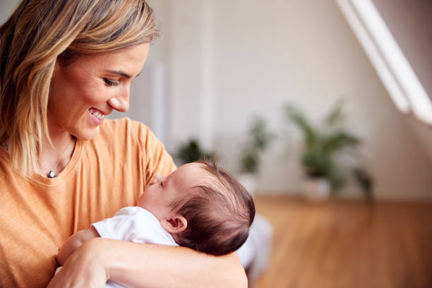 Loving Mother Holding Newborn Baby At Home In Loft Apartment Loving Mother Holding Newborn Baby At Home In Loft Apartment 2 5 months stock pictures, royalty-free photos & images