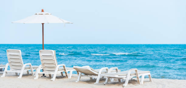 istock White beach chair on the tropical beach 1153669106