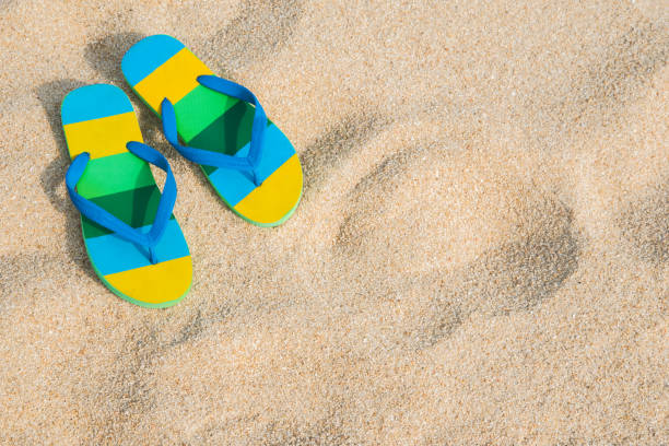 istock Beach sandals on the sandy coast. Summer concept 1153669111