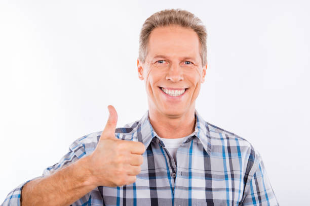 istock Handsome mature man showing gesture thumb up 1153672965
