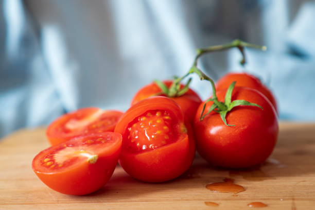 istock organic tomatoes cut on top of a board 1153673234