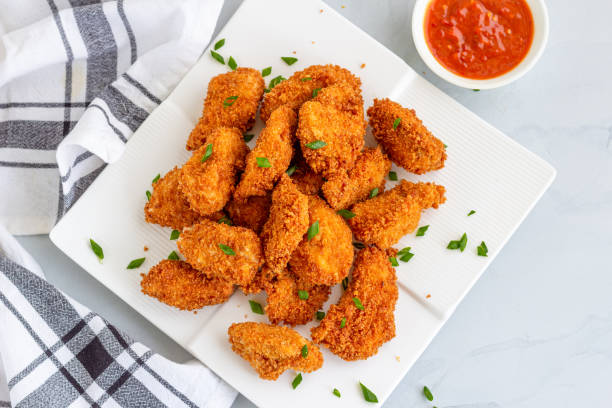 Chicken Nuggets with Ketchup Directly from Above Photo Chicken Nuggets with Ketchup, Popular American Fast Food, Snack, Quick Bites, Appetizer, Directly Above Photo. deep fried photos stock pictures, royalty-free photos & images