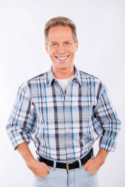 istock Handsome happy aged man keeping hands in pockets 1153673995