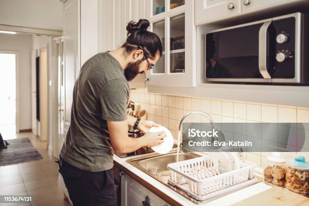 Young Man Washing Dishes At Home Stock Photo - Download Image Now - Men, Washing Dishes, Cleaning