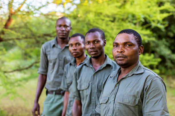 istock Group of African Forest Rangers Facing the Camera for a Portrait 1153674417