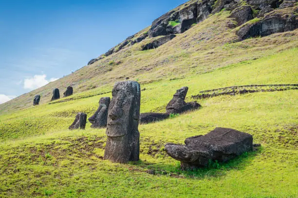 Easter Island Moai Statues at Rano Raraku under sunny summer sky. Rano Raraku, Rapa Nui National Park, Hanga Roa, Easter Island, Chile.