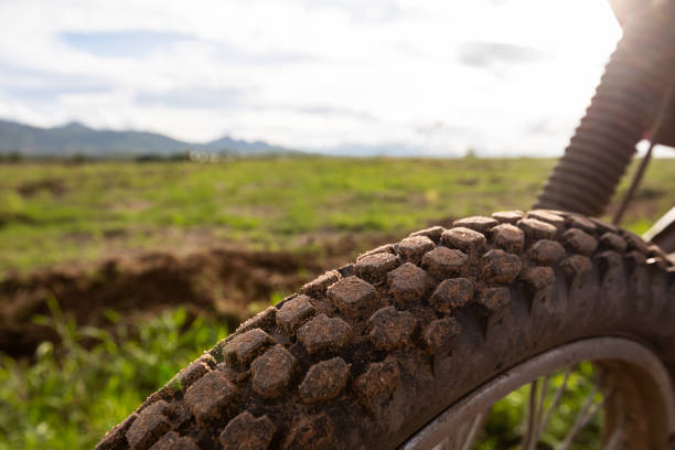 wheel motocross tire tread wheel motocross tire tread with a backdrop of rural landscape scuff marks photos stock pictures, royalty-free photos & images