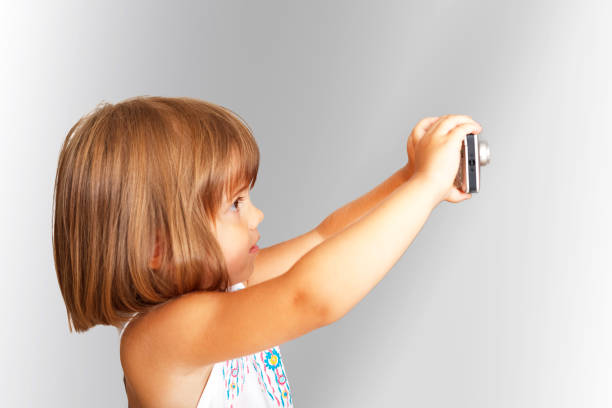 istock Little girl with camera 1153676698