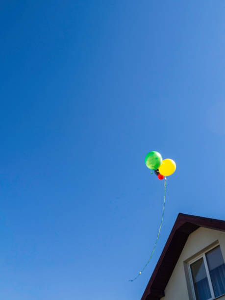istock colorful bouncing balls outdoors against blue sunny sky 1153678097