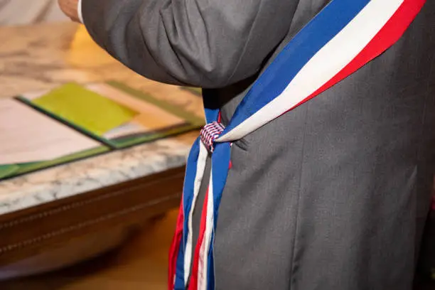 french mayor during official celebration with scarf blue white red sign symbol