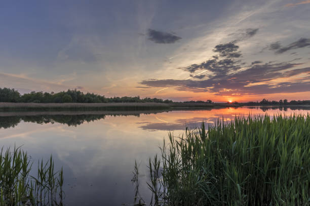 istock Twilight above the pond or lake with cloudy sky at summer with water reflection. 1153679177
