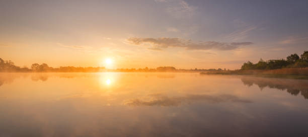 istock Sunrise above the pond with cloudy sky at summer. 1153679234