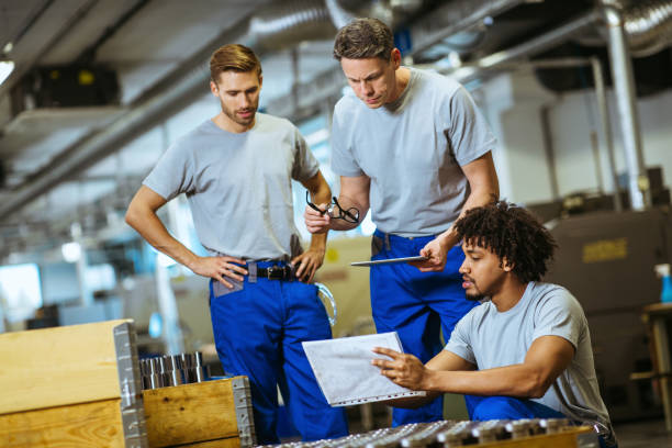 istock Manual workers at warehouse in factory and supervisor evaluate their work 1153682949