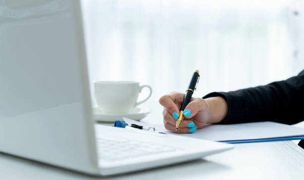 istock Business lady taking business notes at office 1153683204