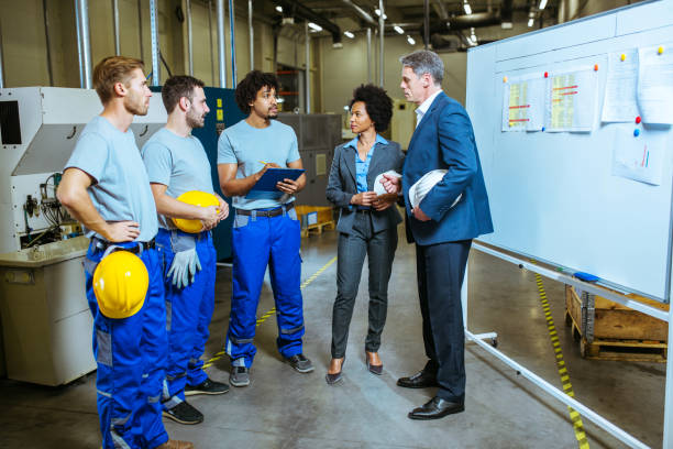 istock Managers and workers having meeting inside of factory 1153683544