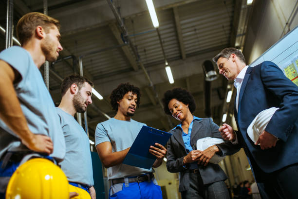 istock Managers and workers having meeting inside of factory 1153684232