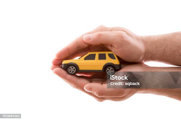 Car Protection Small Yellow Car Covered By Hands Isolated On White Background With Clipping Path Stock Photo - Download Image Now