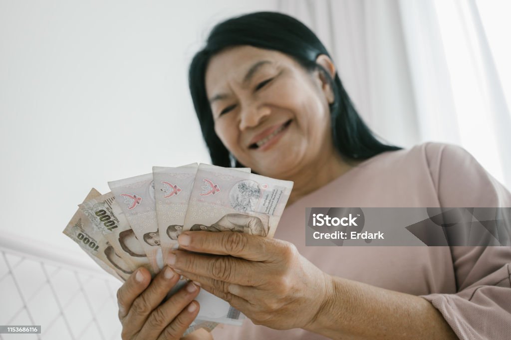 Elderly woman counting Thai money Thailand, Hand, Human Hand, money, Senior Adult, saving, pension Currency Stock Photo