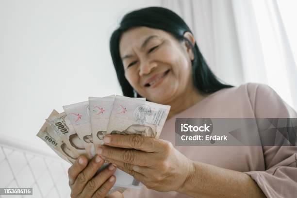 Elderly Woman Counting Thai Money Stock Photo - Download Image Now - Currency, Thai Currency, Receiving