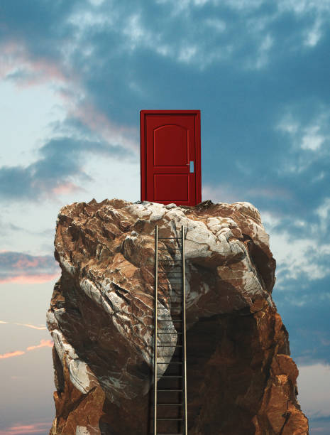 istock Ladder on a mountain peak leading to a closed door. 1153687112
