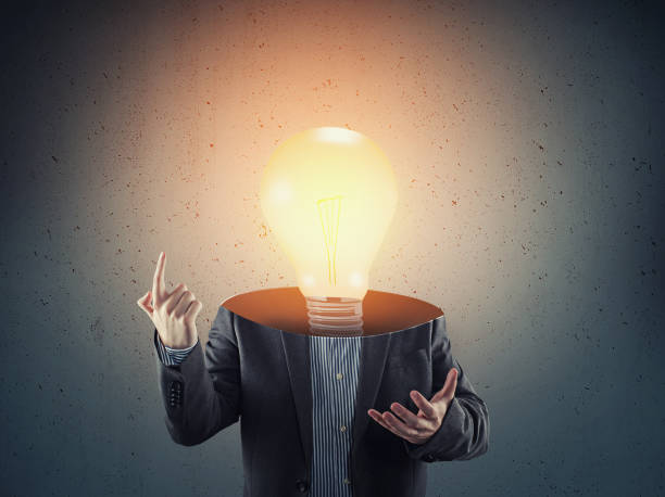 istock Businessman with a lit light bulb instead of head. 1153687168