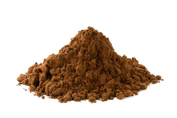 A heap of ground cocoa powder isolated on white.