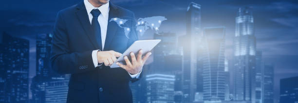 istock Attractive business man working on tablet. Businessman using tablet analyzing sales data and economic. Business innovation technology concept. 1153687451