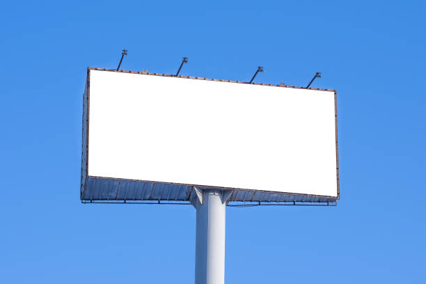 istock Large advertising billboard against the blue sky. White isolated mock up for design and simulation. 1153689049
